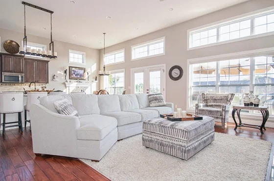 Bright and modern living room with stylish furniture, large windows, and elegant décor, representing completed home remodeling projects.