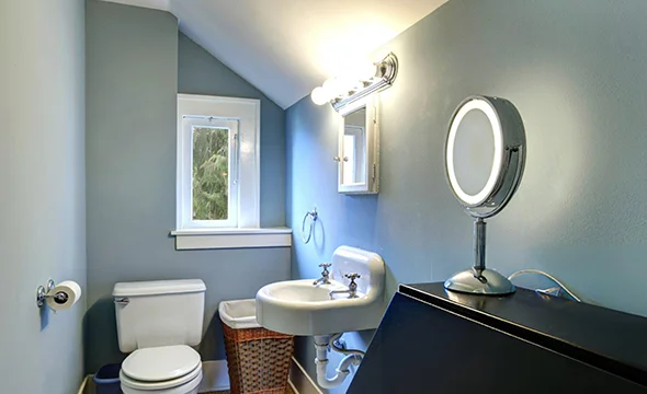 Bathroom with mirror and toilet, featuring cost estimator information for bathroom remodeling in Potomac, MD.
