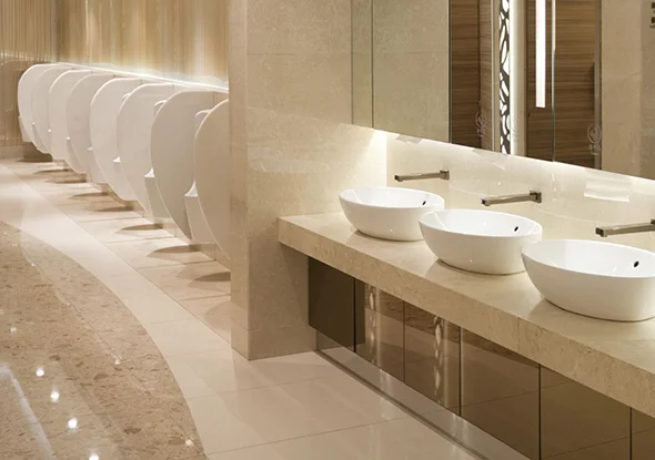 Commercial bathroom with multiple sinks, highlighting commercial bathroom repair and remodeling services in Maryland.