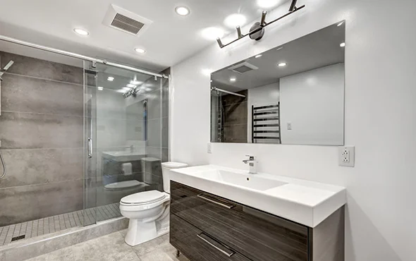 Luxurious bathroom with sleek vanity, large mirrors, and modern tile design, representing expert bathroom remodeling and upgrade services.